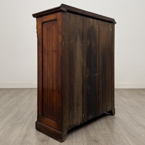 fig 3. A Victorian pitch pine cupboard featuring a single top drawer with brass drop ring handles above a two-door cabinet with vertical panelled detailing.