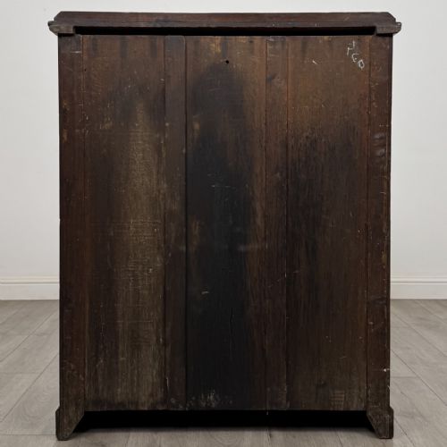 fig 4. A Victorian pitch pine cupboard featuring a single top drawer with brass drop ring handles above a two-door cabinet with vertical panelled detailing.
