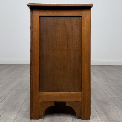 fig 2. A small 20th-century warm brown oak chest of drawers featuring three wide drawers with turned wooden knobs.