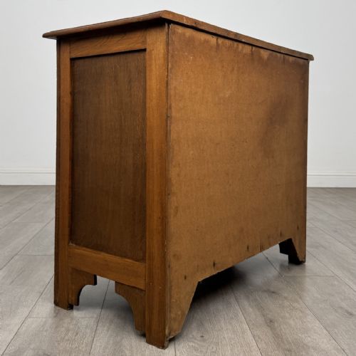 fig 3. A small 20th-century warm brown oak chest of drawers featuring three wide drawers with turned wooden knobs.