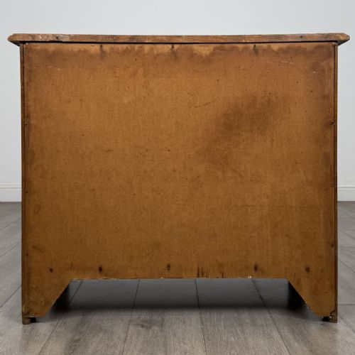 fig 4. A small 20th-century warm brown oak chest of drawers featuring three wide drawers with turned wooden knobs.