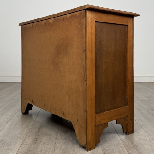 fig 5. A small 20th-century warm brown oak chest of drawers featuring three wide drawers with turned wooden knobs.