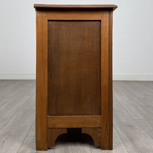 fig 6. A small 20th-century warm brown oak chest of drawers featuring three wide drawers with turned wooden knobs.