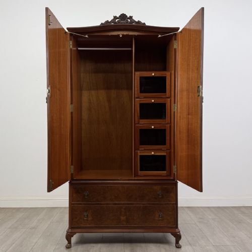 fig 8. A Queen Anne style burr walnut double-door wardrobe featuring two lower drawers, central metal hardware, and carved cabriole legs.