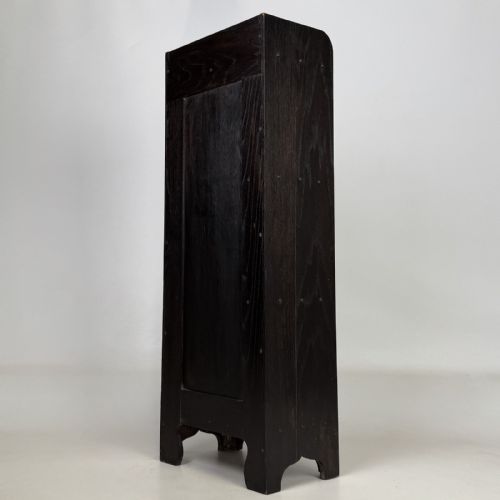 fig 5. A tall narrow dark oak open bookcase featuring a gallery top and three shelves above a shaped base.