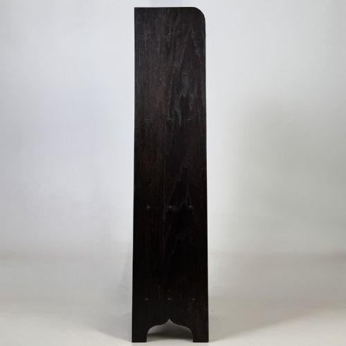 fig 6. A tall narrow dark oak open bookcase featuring a gallery top and three shelves above a shaped base.