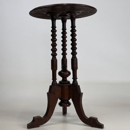 fig 1. A dark brown Victorian lamp table featuring a circular circular top supported by three bobbin-turned upright columns on a tripod base.