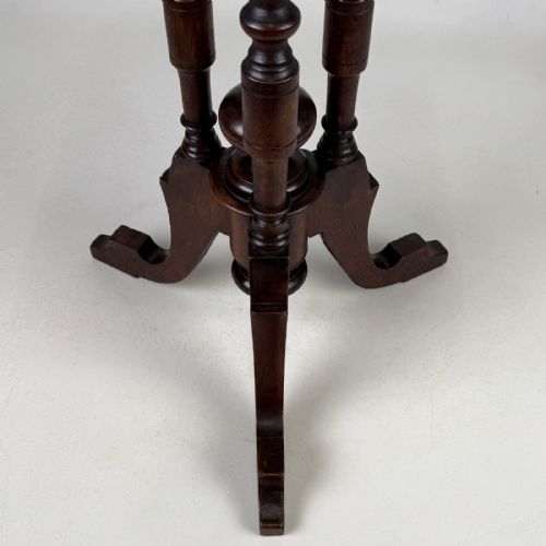 fig 2. A dark brown Victorian lamp table featuring a circular circular top supported by three bobbin-turned upright columns on a tripod base.