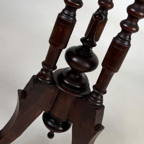 fig 5. A dark brown Victorian lamp table featuring a circular circular top supported by three bobbin-turned upright columns on a tripod base.