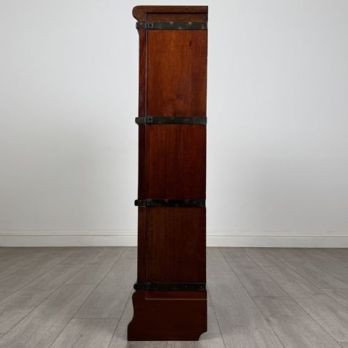 fig 2. A three-tier dark mahogany Globe Wernicke sectional bookcase featuring geometric leaded glass doors.
