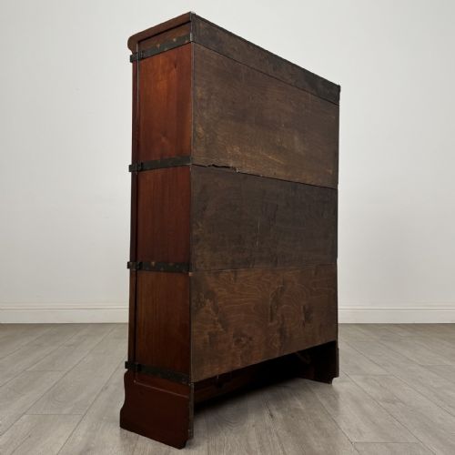 fig 3. A three-tier dark mahogany Globe Wernicke sectional bookcase featuring geometric leaded glass doors.