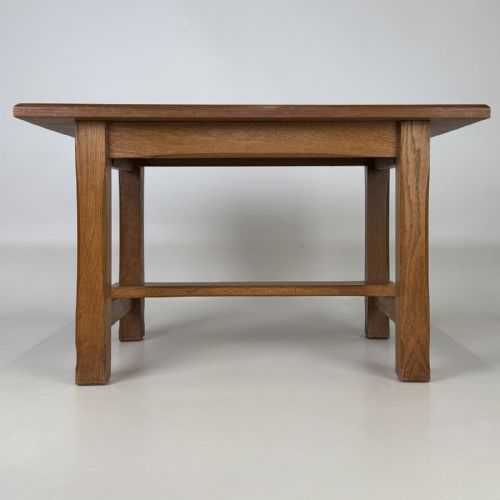 fig 4. A rectangular solid oak coffee table featuring simple square legs joined by low side stretchers in an Arts and Crafts style.