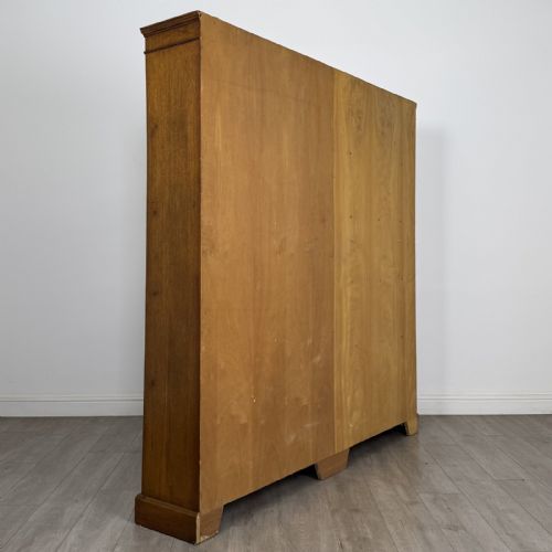 fig 3. A large 20th-century double-width open oak bookcase with a moulded cornice, central vertical divider, and ten spacious open shelves.