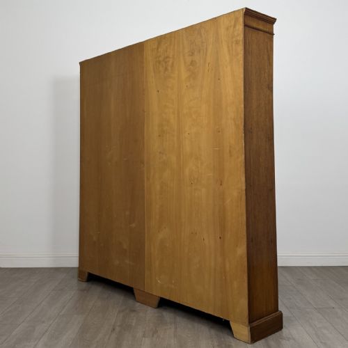 fig 5. A large 20th-century double-width open oak bookcase with a moulded cornice, central vertical divider, and ten spacious open shelves.