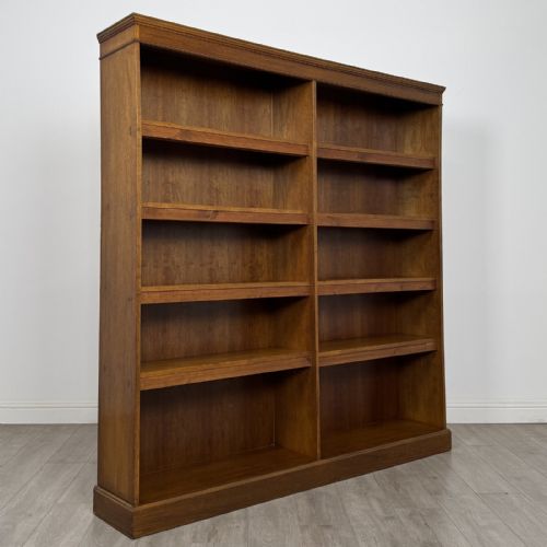 fig 7. A large 20th-century double-width open oak bookcase with a moulded cornice, central vertical divider, and ten spacious open shelves.