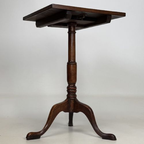 fig 2. An antique Georgian mahogany tilt-top tripod table featuring a square top supported by a turned central column and three cabriole legs with pad feet.