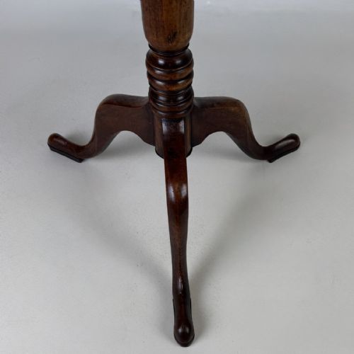 fig 6. An antique Georgian mahogany tilt-top tripod table featuring a square top supported by a turned central column and three cabriole legs with pad feet.
