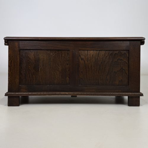 fig 4. A rectangular dark oak coffer with three carved linenfold panels along the front facade.