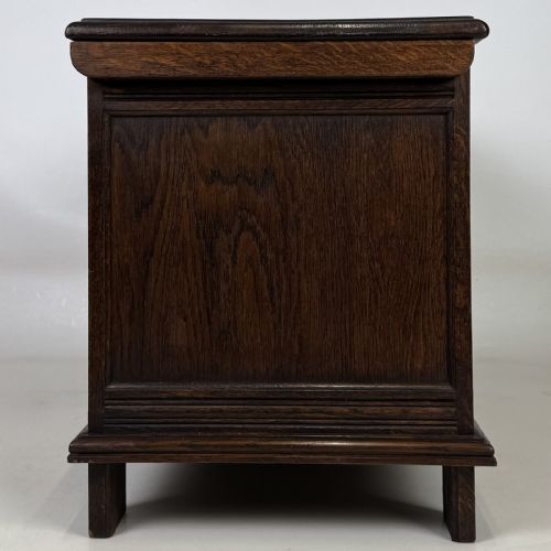 fig 6. A rectangular dark oak coffer with three carved linenfold panels along the front facade.