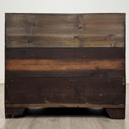 fig 4. A Georgian mahogany chest of drawers featuring four graduated drawers with oval brass handles and splayed bracket feet.