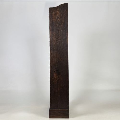 fig 3. A tall and narrow early 20th-century dark oak open bookcase with five shelf levels and a shaped top gallery.