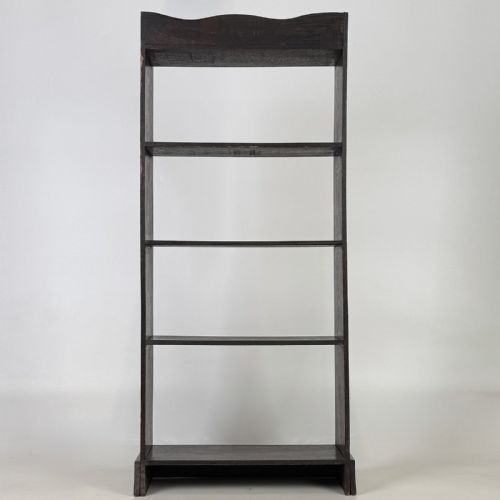 fig 5. A tall and narrow early 20th-century dark oak open bookcase with five shelf levels and a shaped top gallery.