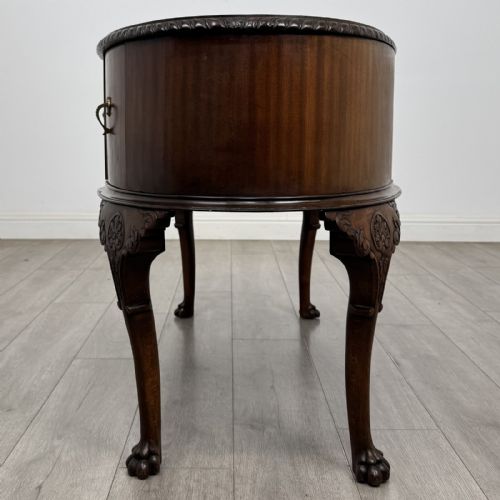 fig 2. A Chippendale style mahogany oval desk featuring cabriole legs with carved knees, ball-and-claw feet, side drawers, and a central kneehole.