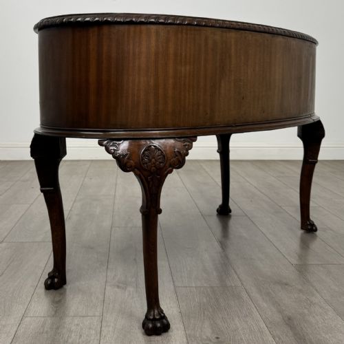 fig 3. A Chippendale style mahogany oval desk featuring cabriole legs with carved knees, ball-and-claw feet, side drawers, and a central kneehole.