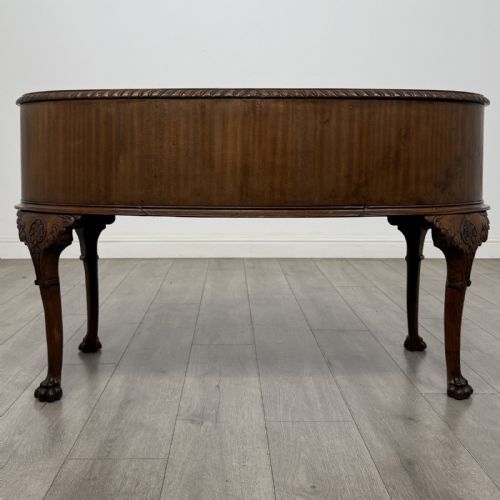 fig 4. A Chippendale style mahogany oval desk featuring cabriole legs with carved knees, ball-and-claw feet, side drawers, and a central kneehole.