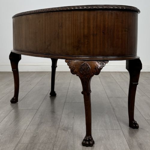 fig 5. A Chippendale style mahogany oval desk featuring cabriole legs with carved knees, ball-and-claw feet, side drawers, and a central kneehole.