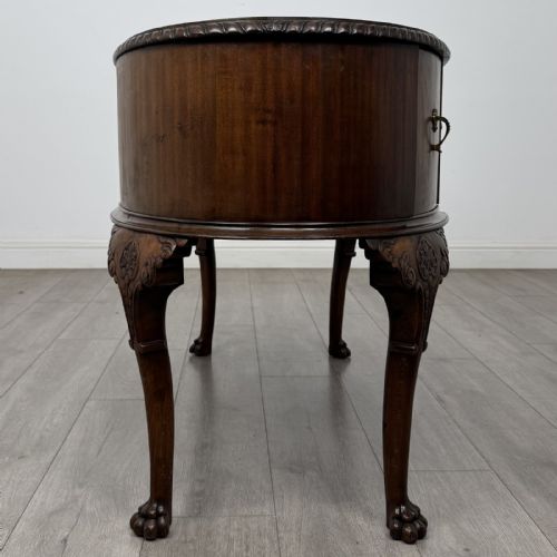 fig 6. A Chippendale style mahogany oval desk featuring cabriole legs with carved knees, ball-and-claw feet, side drawers, and a central kneehole.