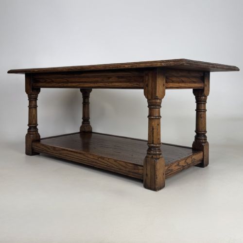 fig 1. A rectangular dark oak Jacobean style coffee table featuring turned baluster legs and a lower potboard shelf.