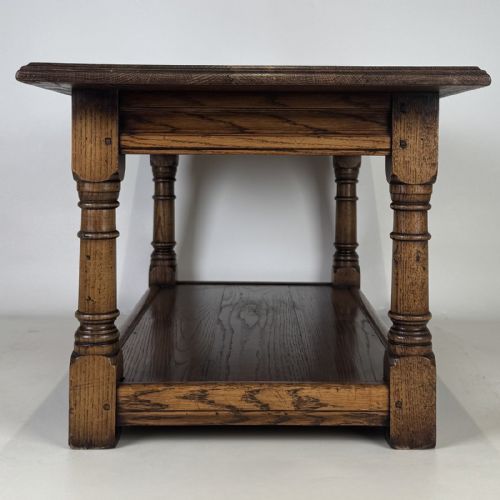 fig 2. A rectangular dark oak Jacobean style coffee table featuring turned baluster legs and a lower potboard shelf.