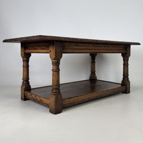 fig 3. A rectangular dark oak Jacobean style coffee table featuring turned baluster legs and a lower potboard shelf.