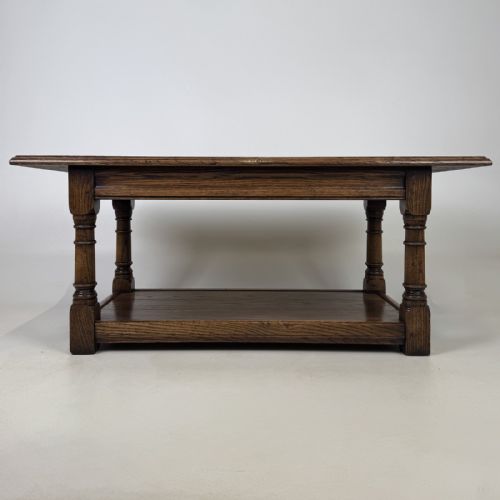 fig 4. A rectangular dark oak Jacobean style coffee table featuring turned baluster legs and a lower potboard shelf.