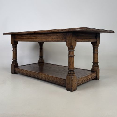 fig 5. A rectangular dark oak Jacobean style coffee table featuring turned baluster legs and a lower potboard shelf.