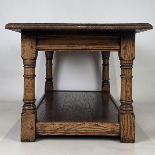 fig 6. A rectangular dark oak Jacobean style coffee table featuring turned baluster legs and a lower potboard shelf.