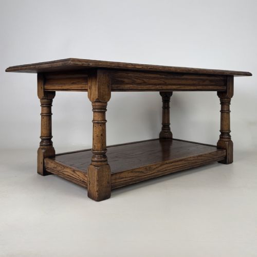 fig 7. A rectangular dark oak Jacobean style coffee table featuring turned baluster legs and a lower potboard shelf.