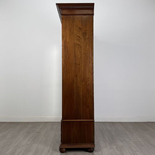 fig 2. An antique early 20th-century walnut double wardrobe featuring a full-length mirror door, panelled right door, geometric mouldings, and a single lower drawer.