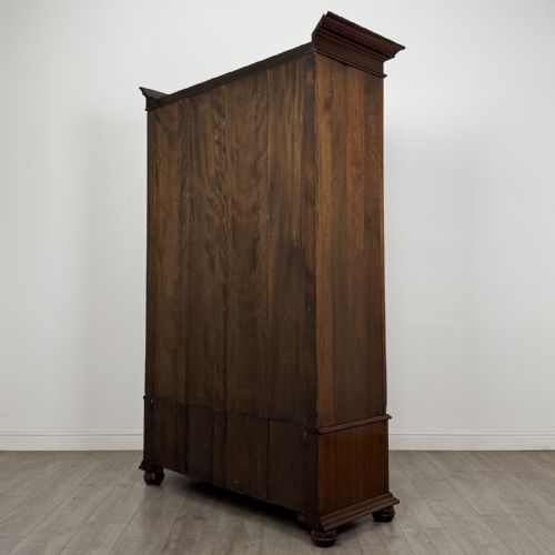 fig 5. An antique early 20th-century walnut double wardrobe featuring a full-length mirror door, panelled right door, geometric mouldings, and a single lower drawer.