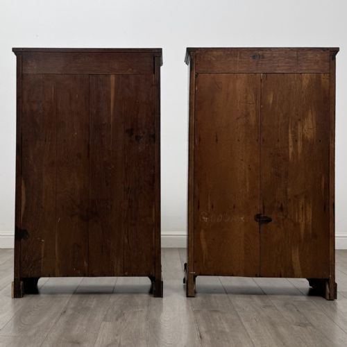 fig 7. A matching pair of dark oak Edwardian open bookcases featuring carved cornices, three shelves, and shaped plinth bases.