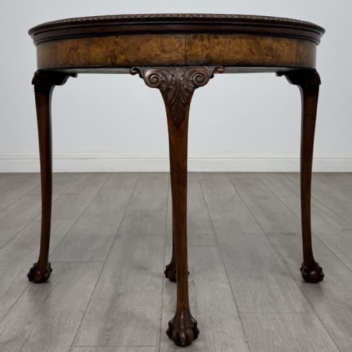 fig 1. A Georgian style burr walnut card table featuring carved cabriole legs terminating in ball and claw feet.