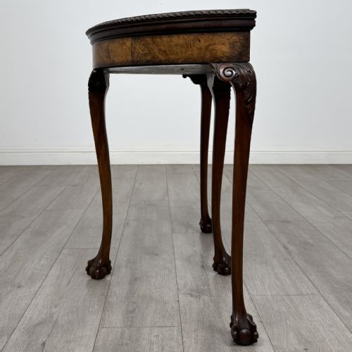 fig 4. A Georgian style burr walnut card table featuring carved cabriole legs terminating in ball and claw feet.