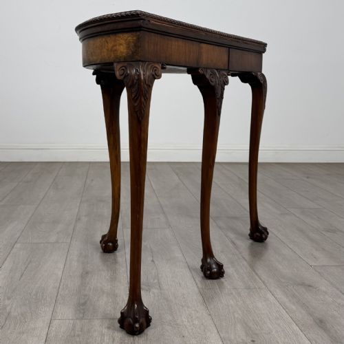 fig 6. A Georgian style burr walnut card table featuring carved cabriole legs terminating in ball and claw feet.