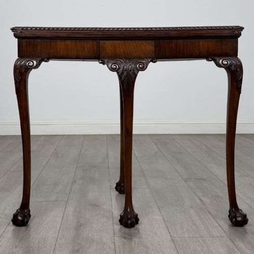 fig 7. A Georgian style burr walnut card table featuring carved cabriole legs terminating in ball and claw feet.