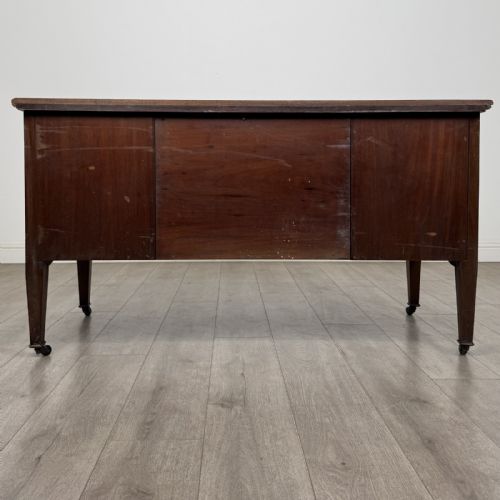 fig 5. An Edwardian inlaid mahogany sideboard with cherub marquetry panels, a central arched alcove, drawer, and square tapered legs with castors.