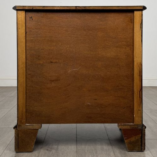 fig 4. A dark brown mahogany Georgian style chest of drawers featuring four drawers, fluted side pilasters, circular handles, and bracket feet.