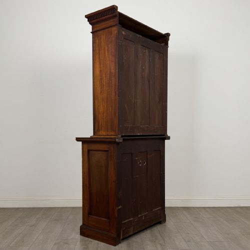 fig 3. A Victorian walnut glazed bookcase featuring a two-door glass display upper section above two drawers and a double cupboard base.
