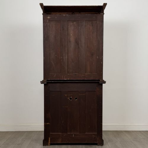 fig 4. A Victorian walnut glazed bookcase featuring a two-door glass display upper section above two drawers and a double cupboard base.