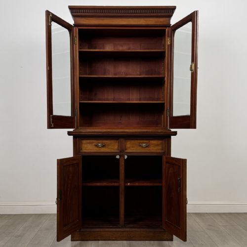 fig 8. A Victorian walnut glazed bookcase featuring a two-door glass display upper section above two drawers and a double cupboard base.